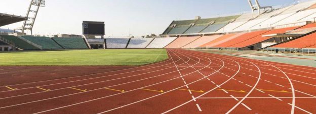 Red and green track in a stadium.